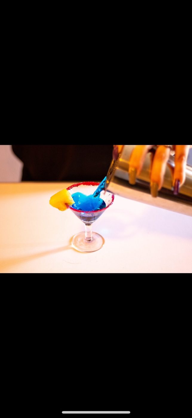 Blue cocktail being prepared